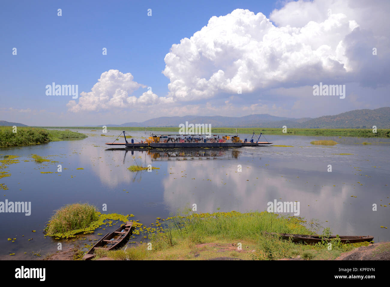 Uganda is called 'The pearl of Africa' because of its beautiful landscapes, friendly people, and abundance of rain. Ferry crossing the Nile river Stock Photo
