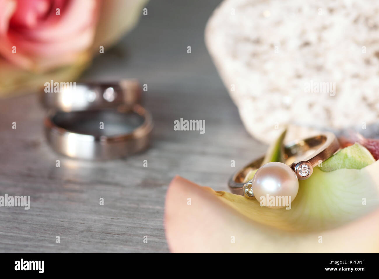 Romantic still life with a Rose and wedding rings Stock Photo