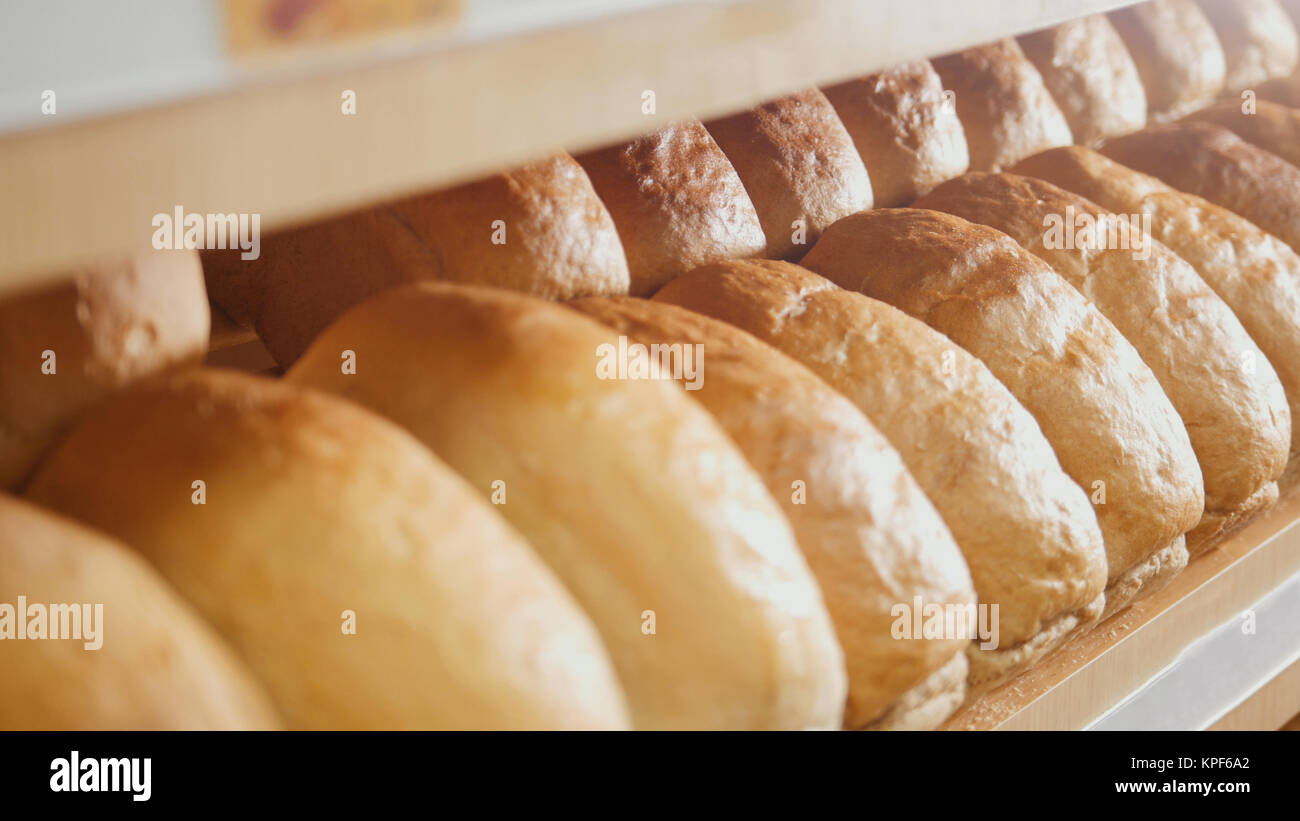 Many loaves of bread on a tray for sale Stock Photo Alamy