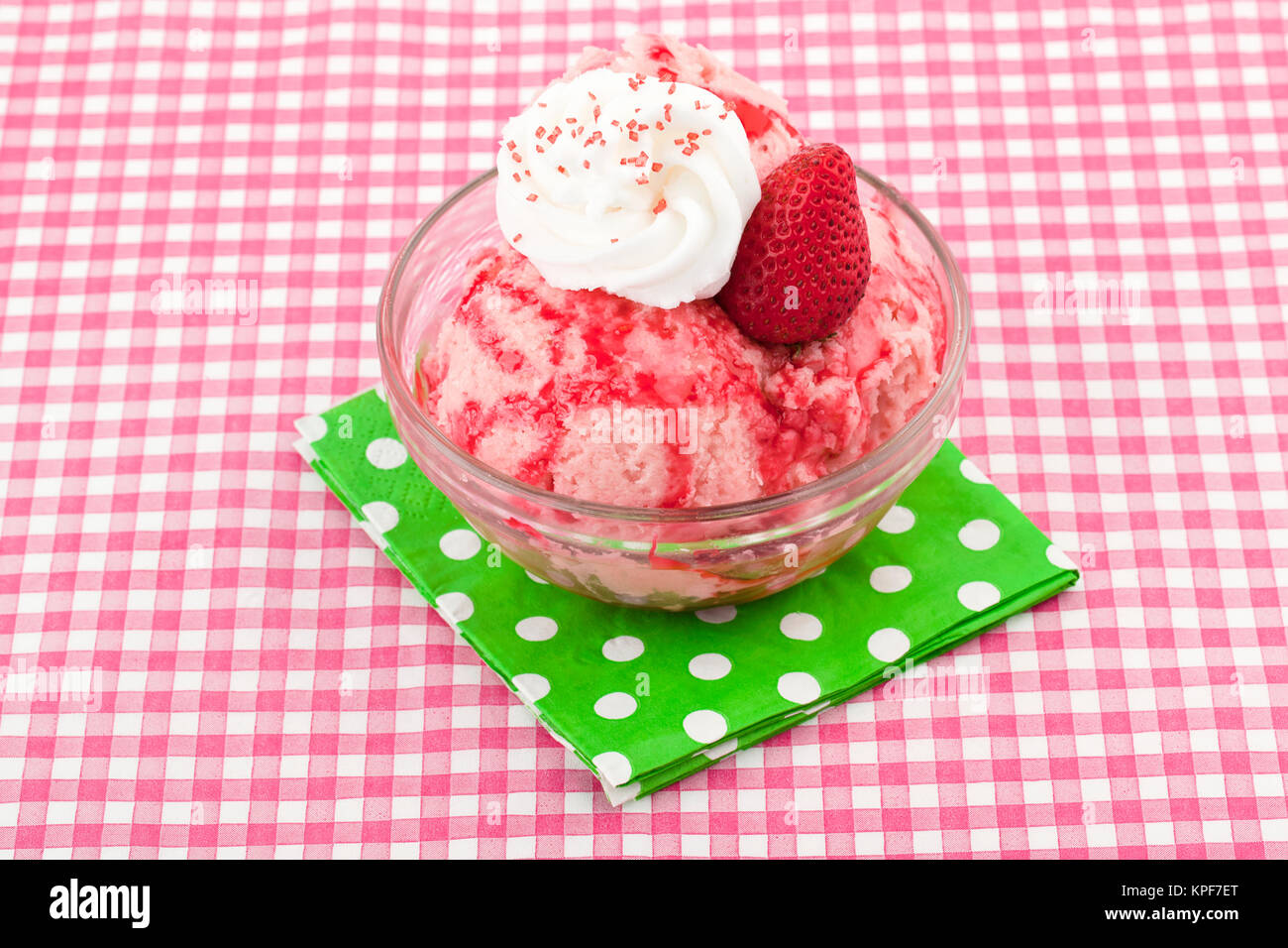 strawberry ice cream with whipped cream syrup and strawberry toppings