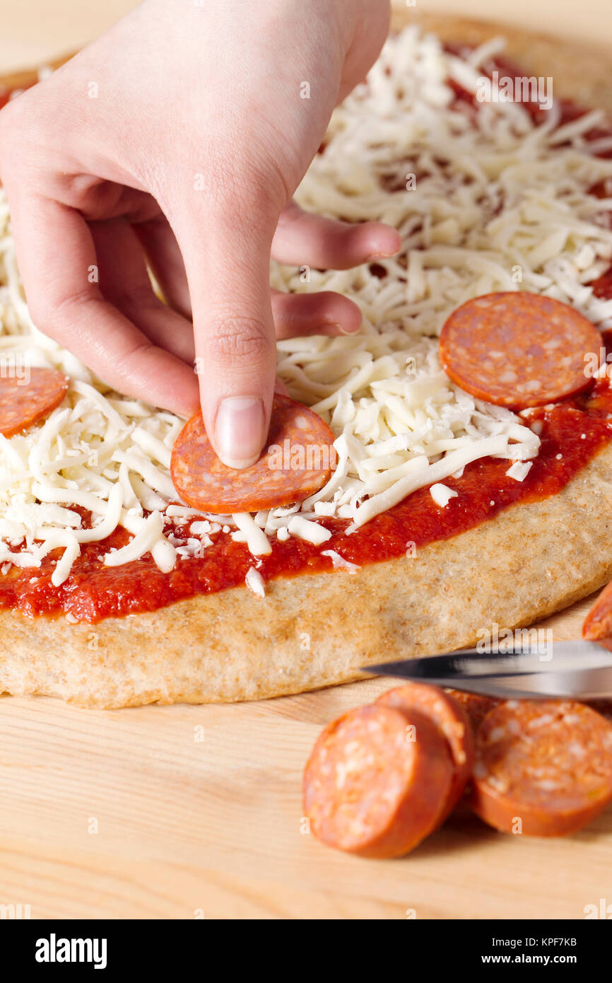 putting sausage on a pizza Stock Photo Alamy