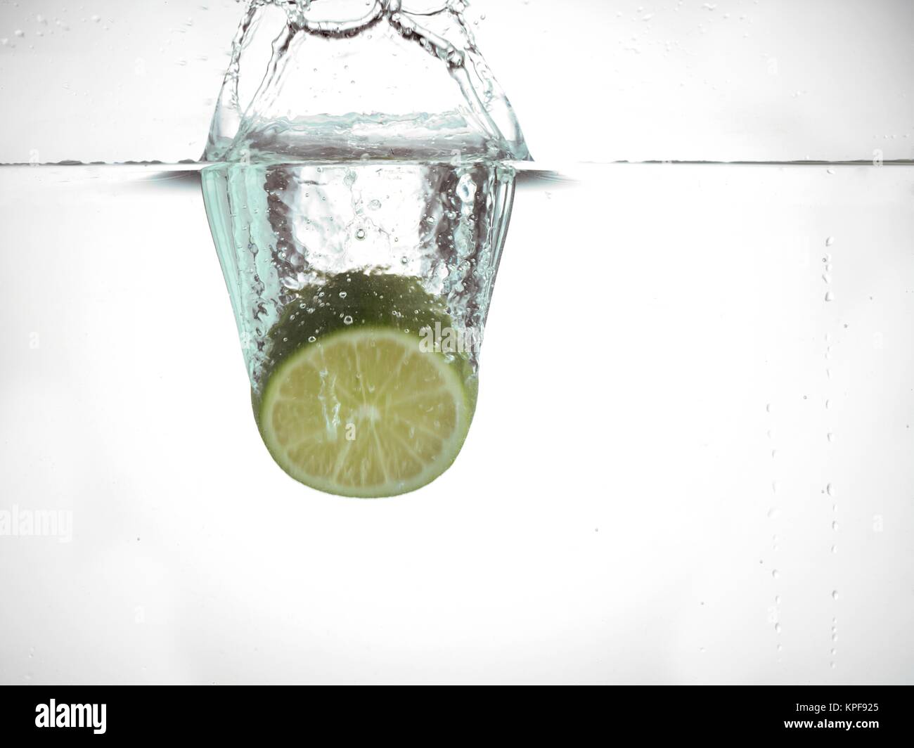 dropping lime in water Stock Photo Alamy