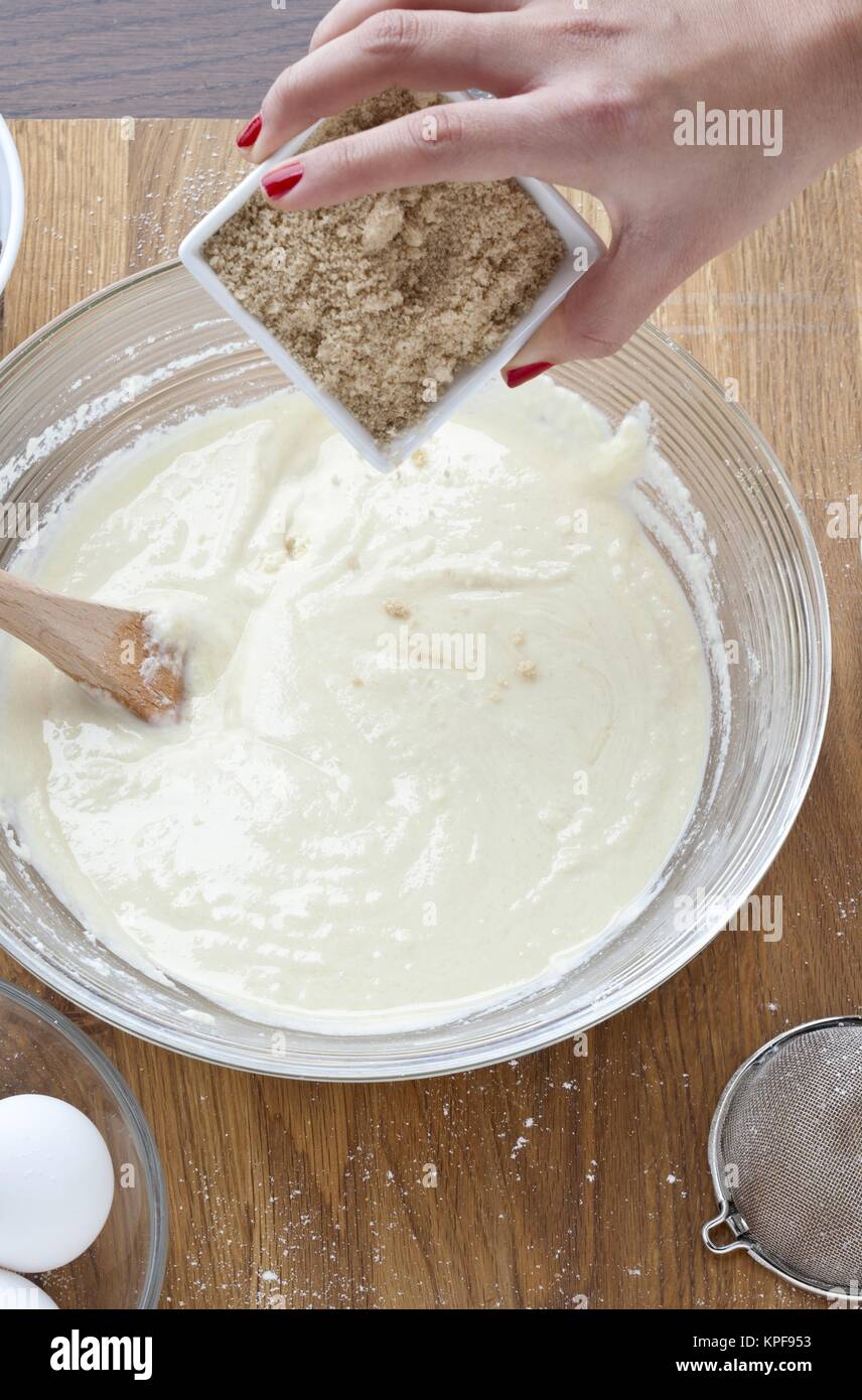 female adding brown sugar into a paste Stock Photo - Alamy