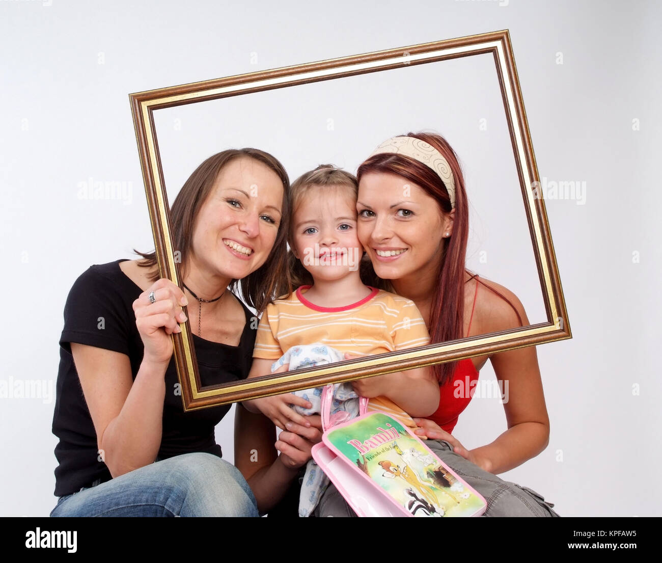 Zwei Frauen mit Kind im Bilderrahmen - women with little girl in a picture frame Stock Photo