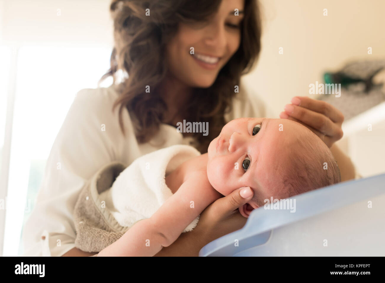 Mother washing a newborn baby in a bath tub Stock Photo Alamy