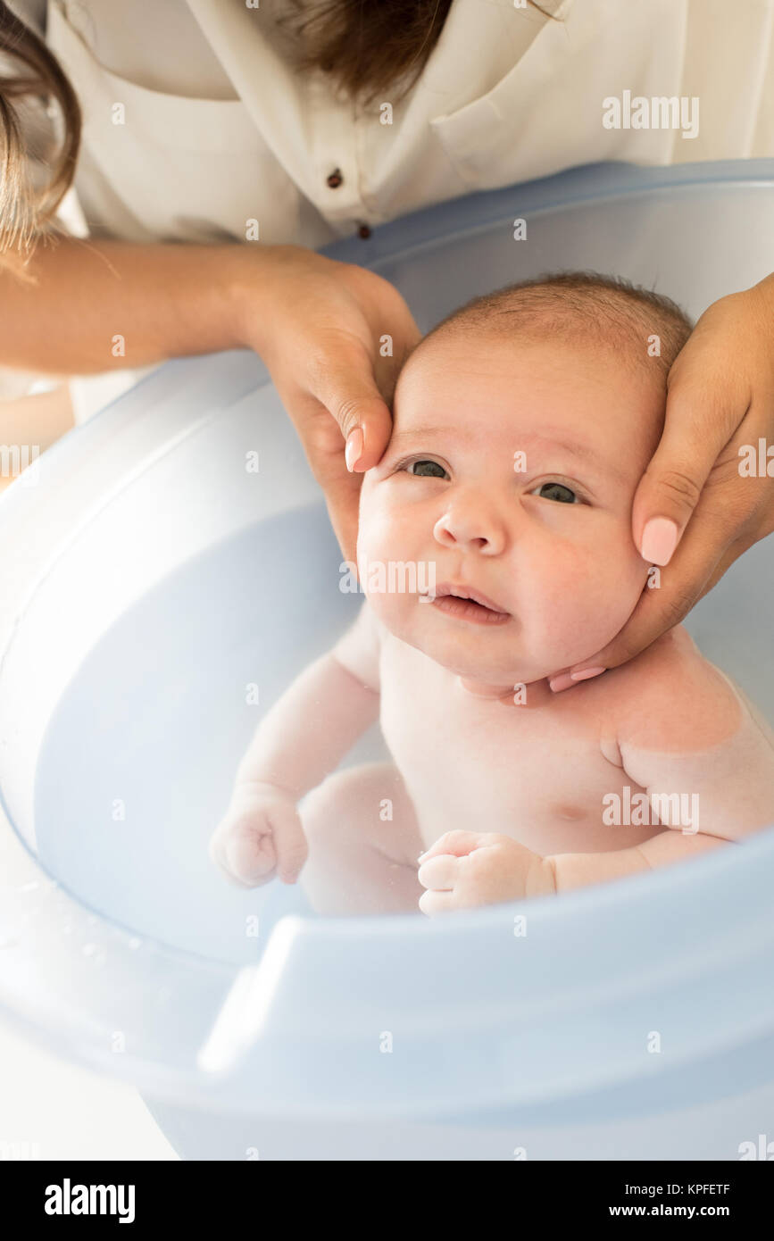 Adorable newborn baby having a bath by the mother Stock Photo Alamy