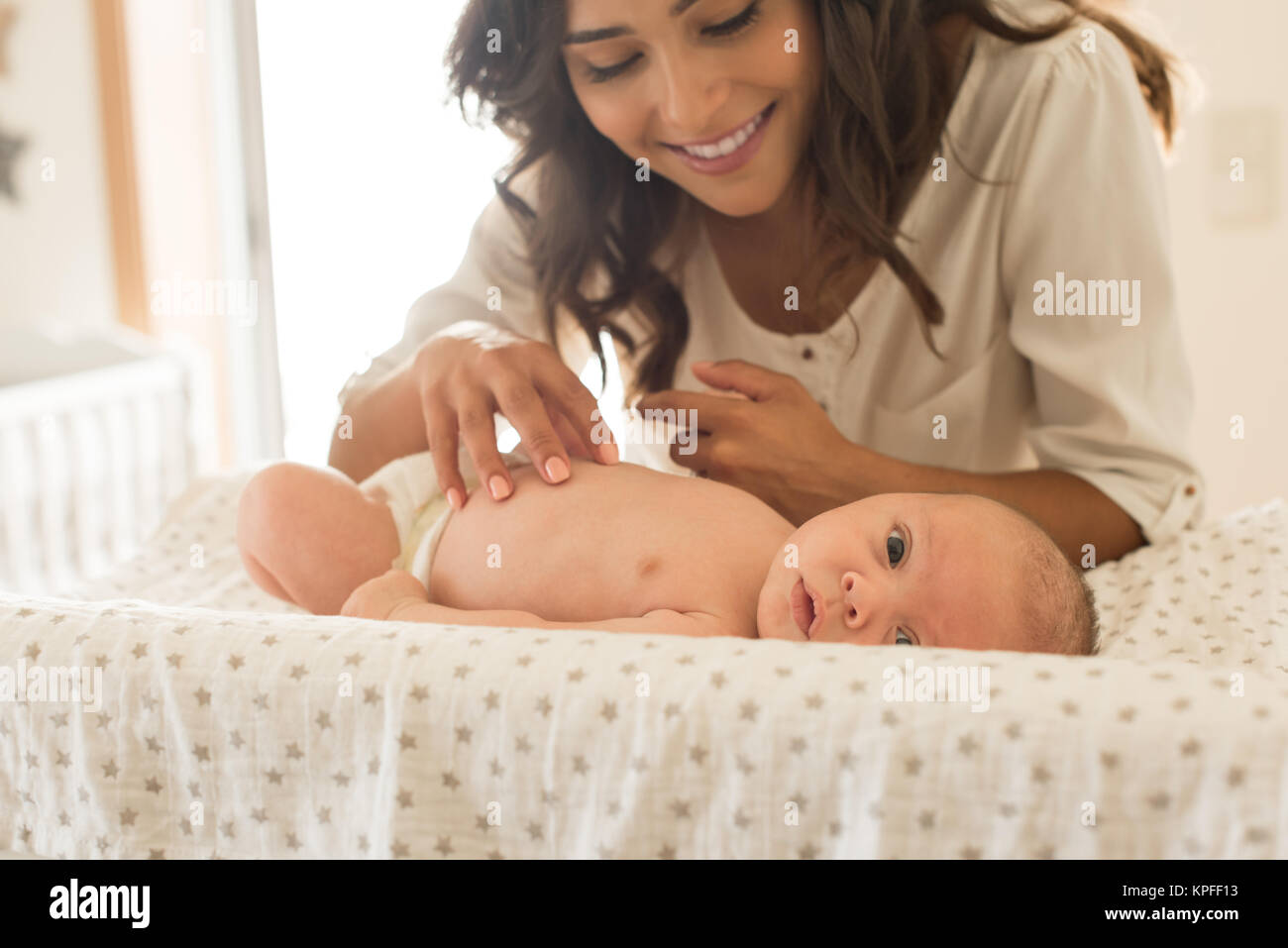 Young Mother moisturizing baby's skin after bath Stock Photo Alamy