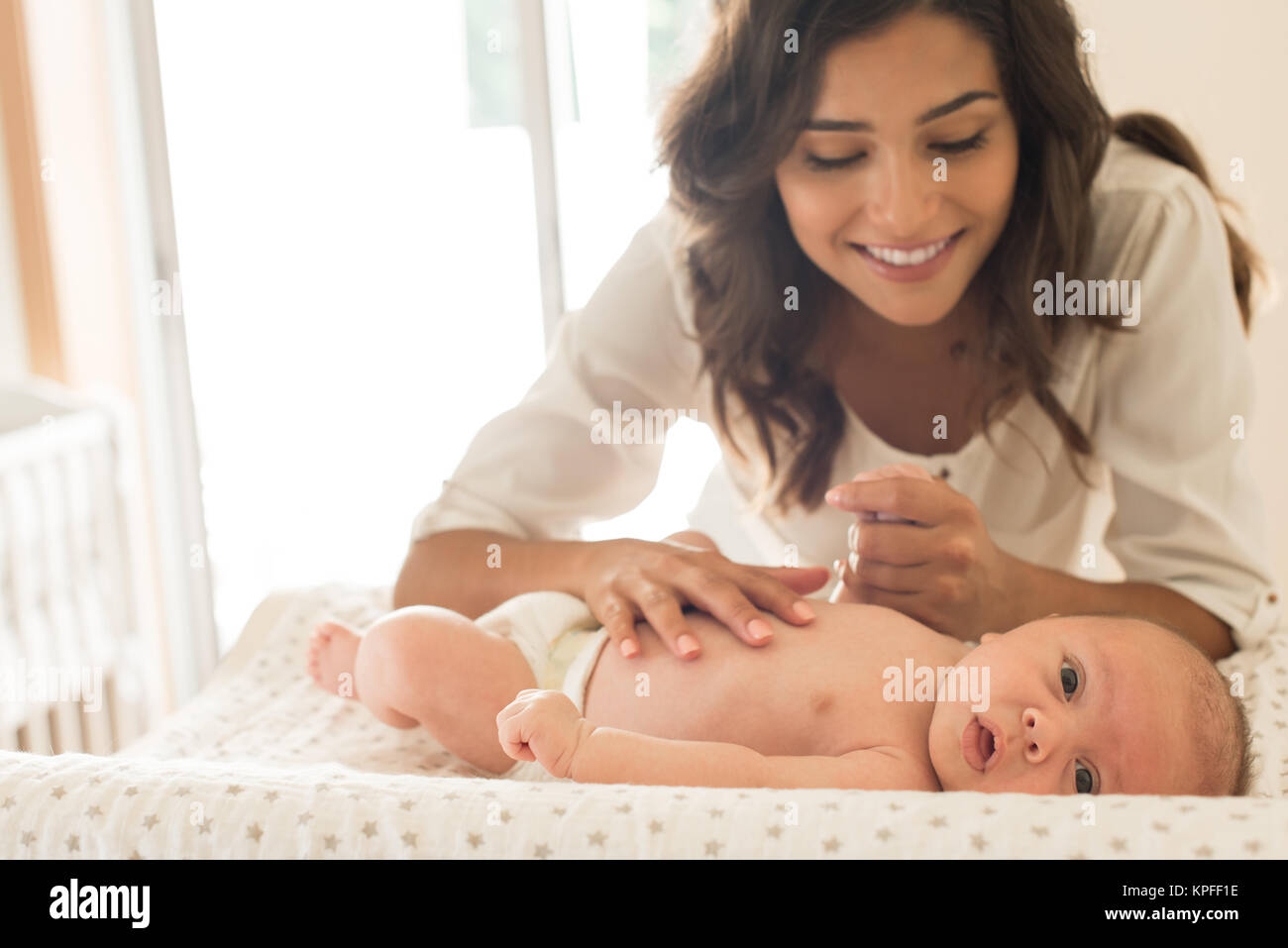 Young Mother moisturizing baby's skin after bath Stock Photo Alamy