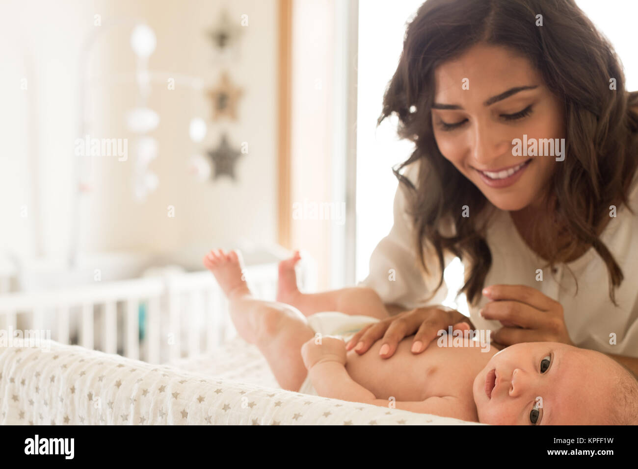 Young Mother moisturizing baby's skin after bath Stock Photo Alamy