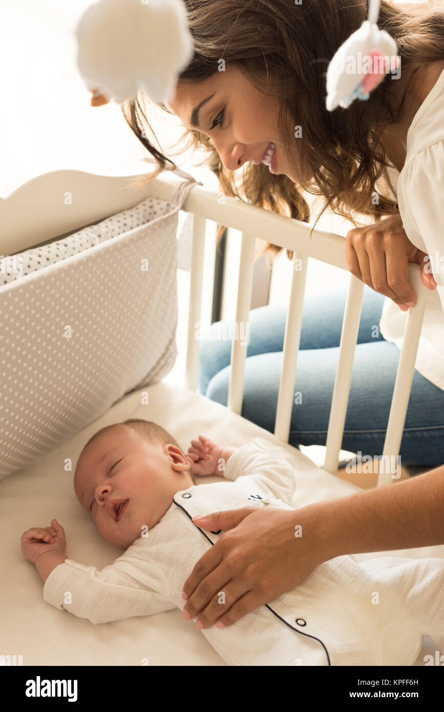 Mother putting baby to sleep at the crib Stock Photo Alamy