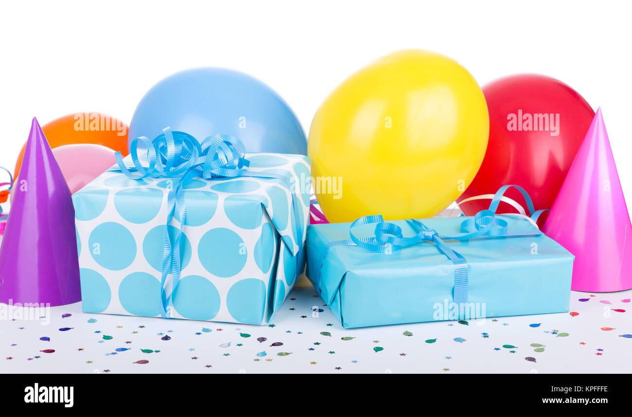 Blue birthday presents with balloons and party hats on white background Stock Photo