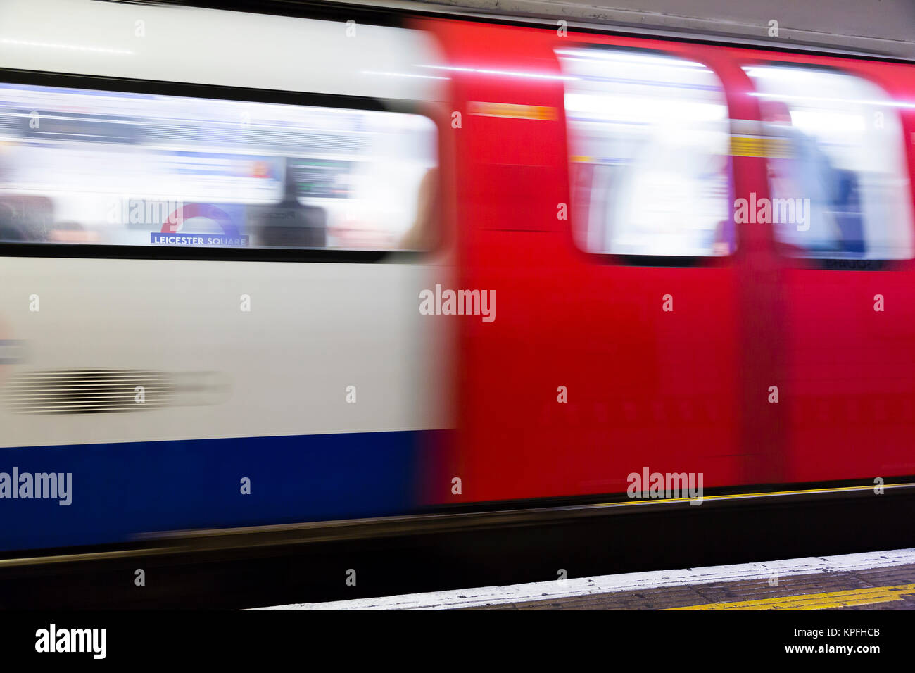 London, UK. A tube station rushing along the platform at Leicester Square. Stock Photo
