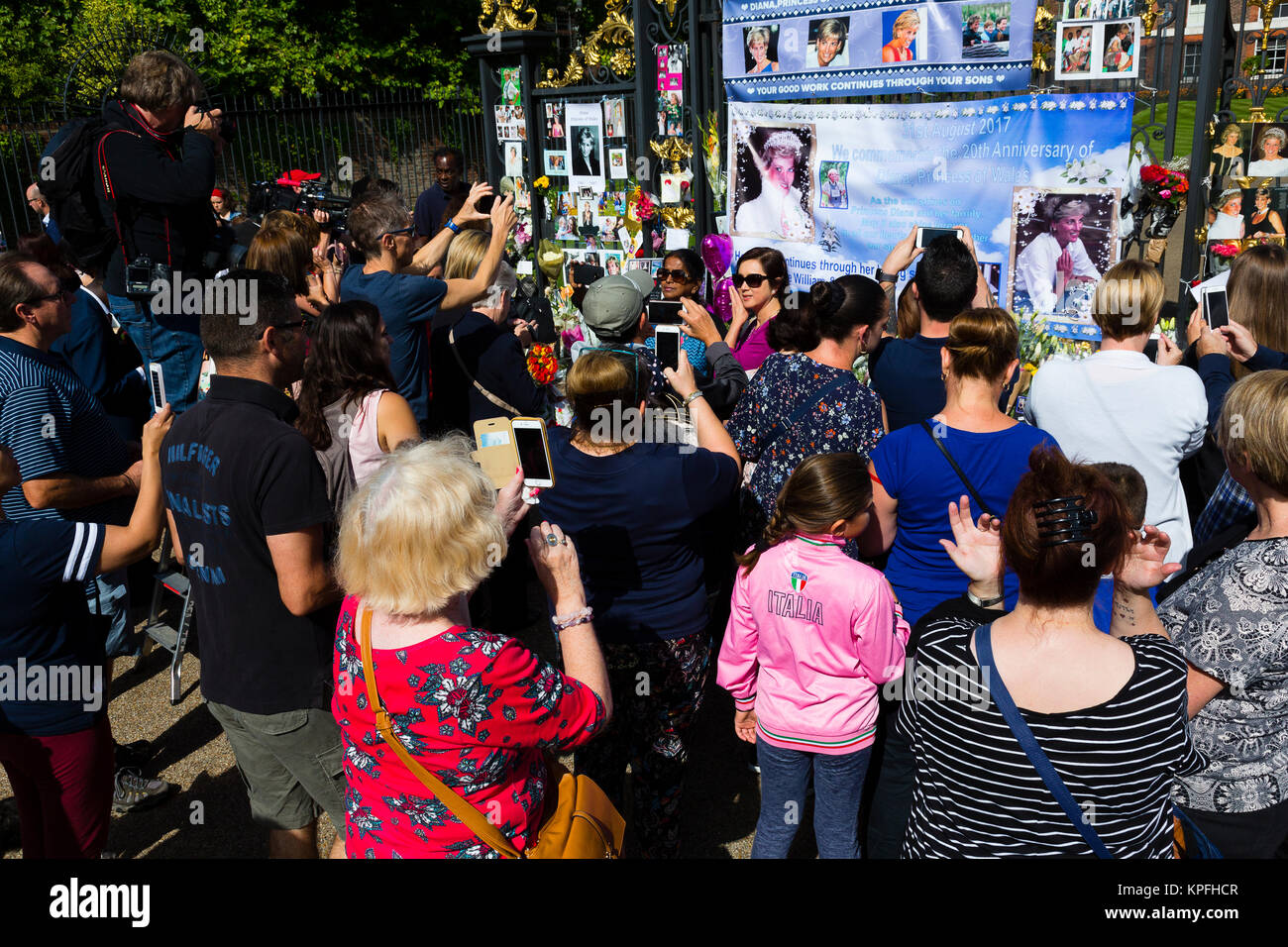 London, UK. A crowd takes pictures with mobile phones of a memorial dedicated to the 20th anniversary of the death of Diana Princess of Wales. Stock Photo