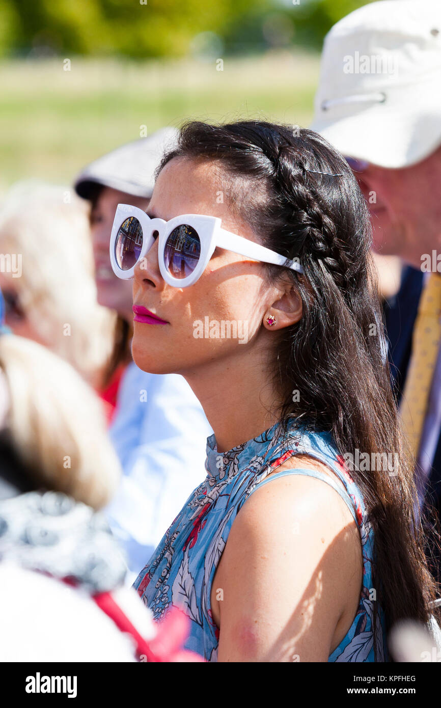 London, UK. A young woman with plaited hair and sunglasses watches at a memorial commemorating the 20th anniversary of the death of Diana Princess of  Stock Photo
