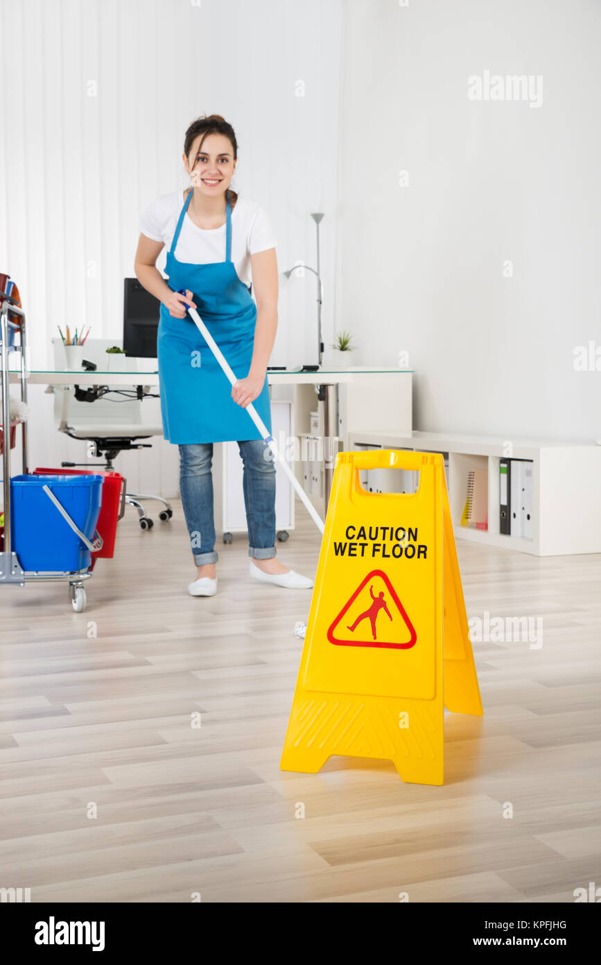 Female Janitor Mopping Wooden Floor Stock Photo Alamy