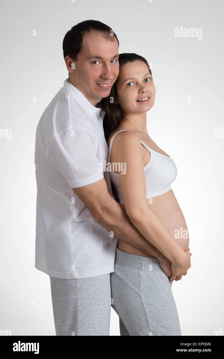 Man Embracing Pregnant Woman Stock Photo - Alamy