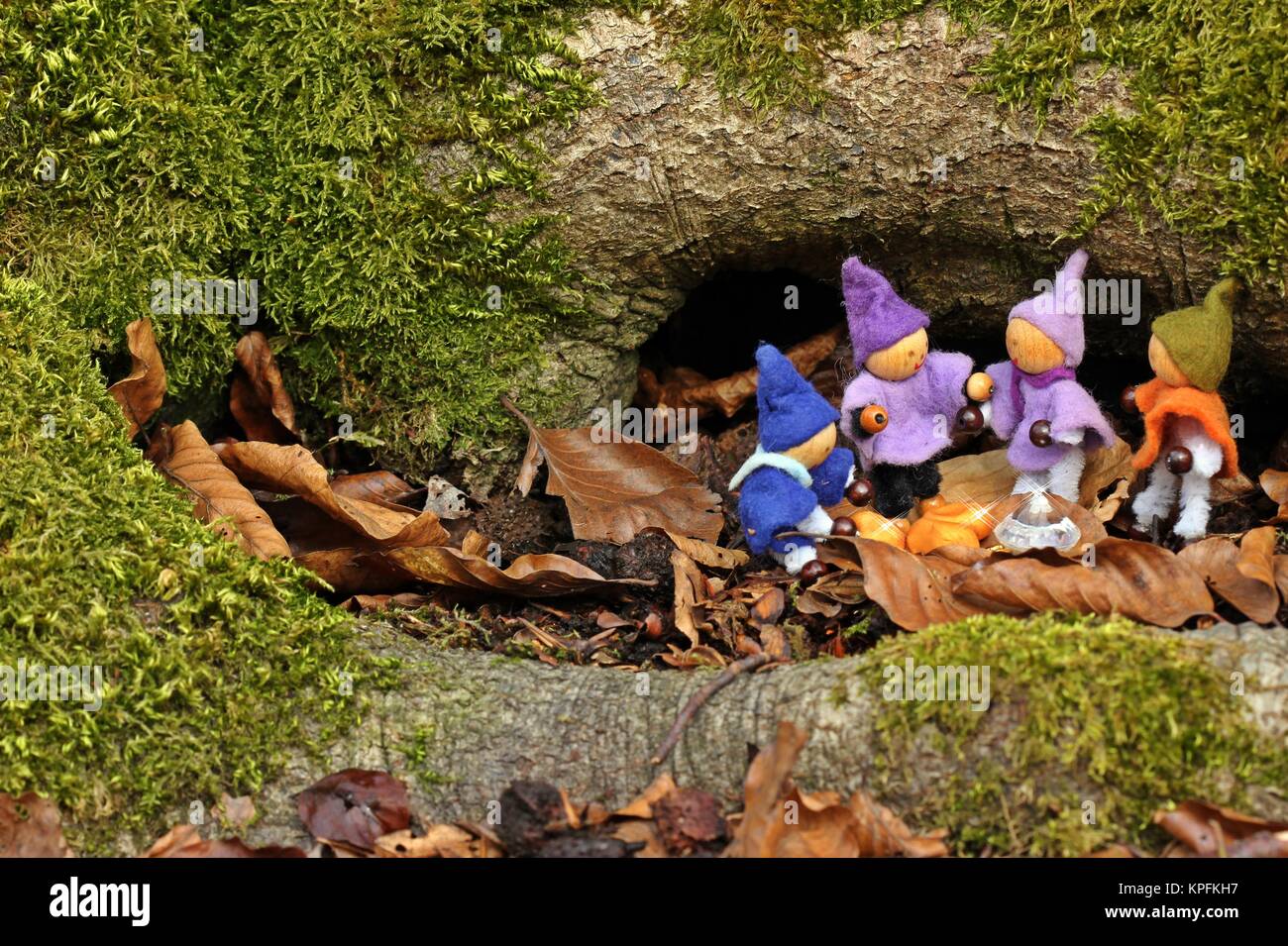 Four little gnomes find a treasure Stock Photo