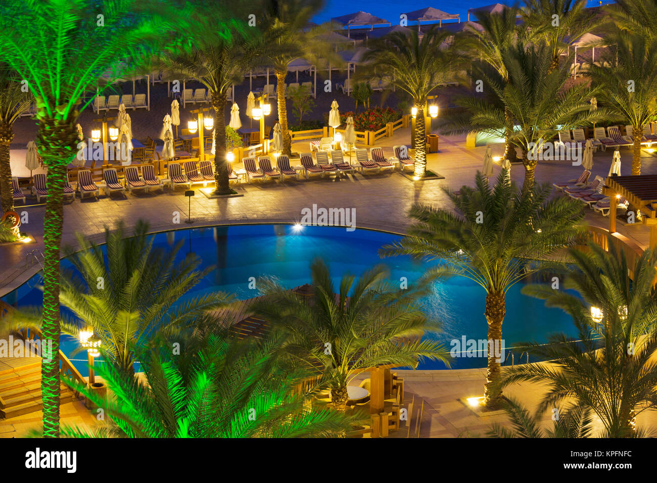 Jordan, Aqaba, elevated view of hotel swimming pool, dusk Stock Photo