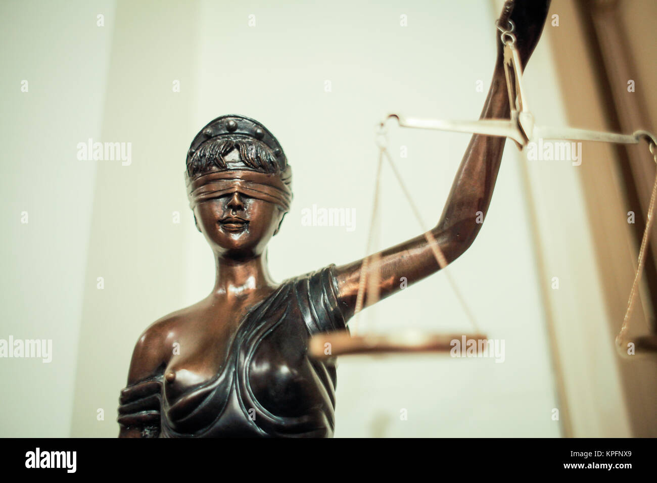 Bronze statue of the blind and impartial Lady Justice holding scales