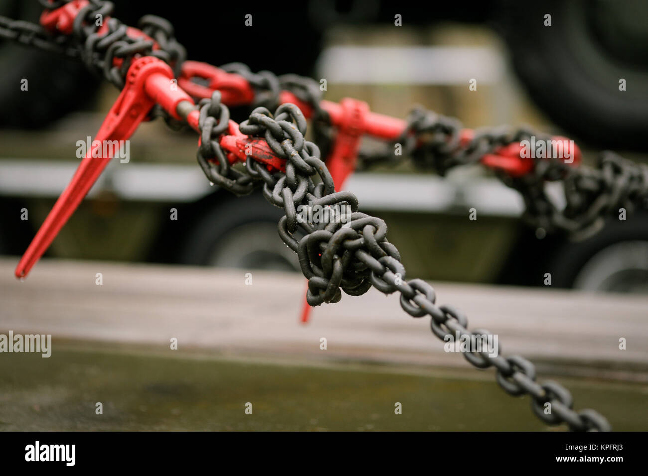 Heavy metal chain and hook anchores an armoured vehicle Stock Photo - Alamy