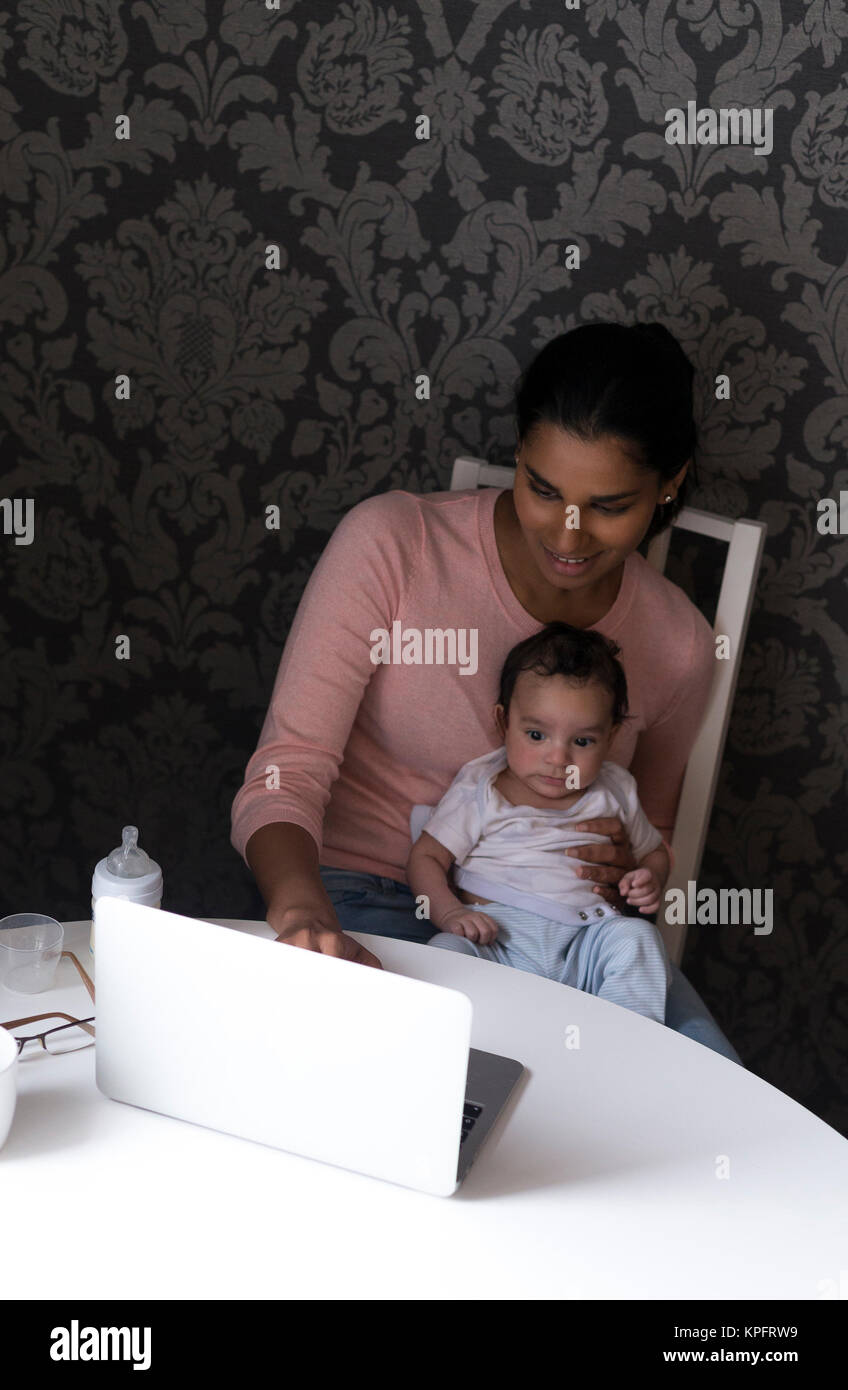 Mother and baby using laptop Stock Photo - Alamy