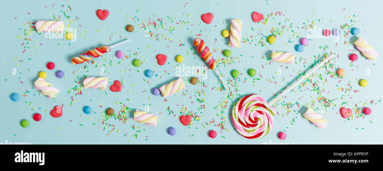 Colorful candies on light blue background, top view Stock Photo