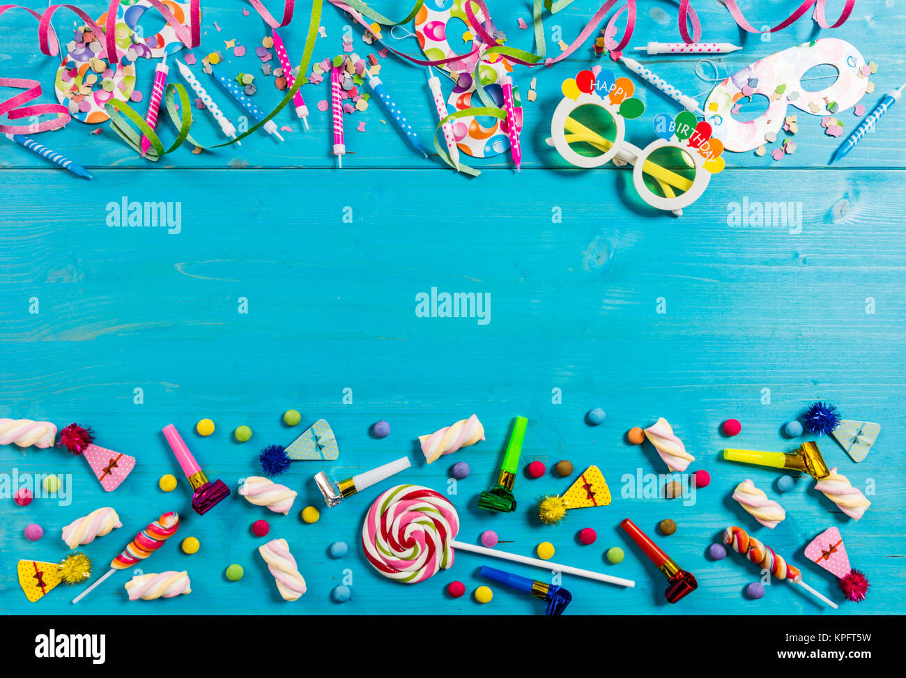 Colorful birthday party supplies on blue wooden background, top niew and copy space Stock Photo