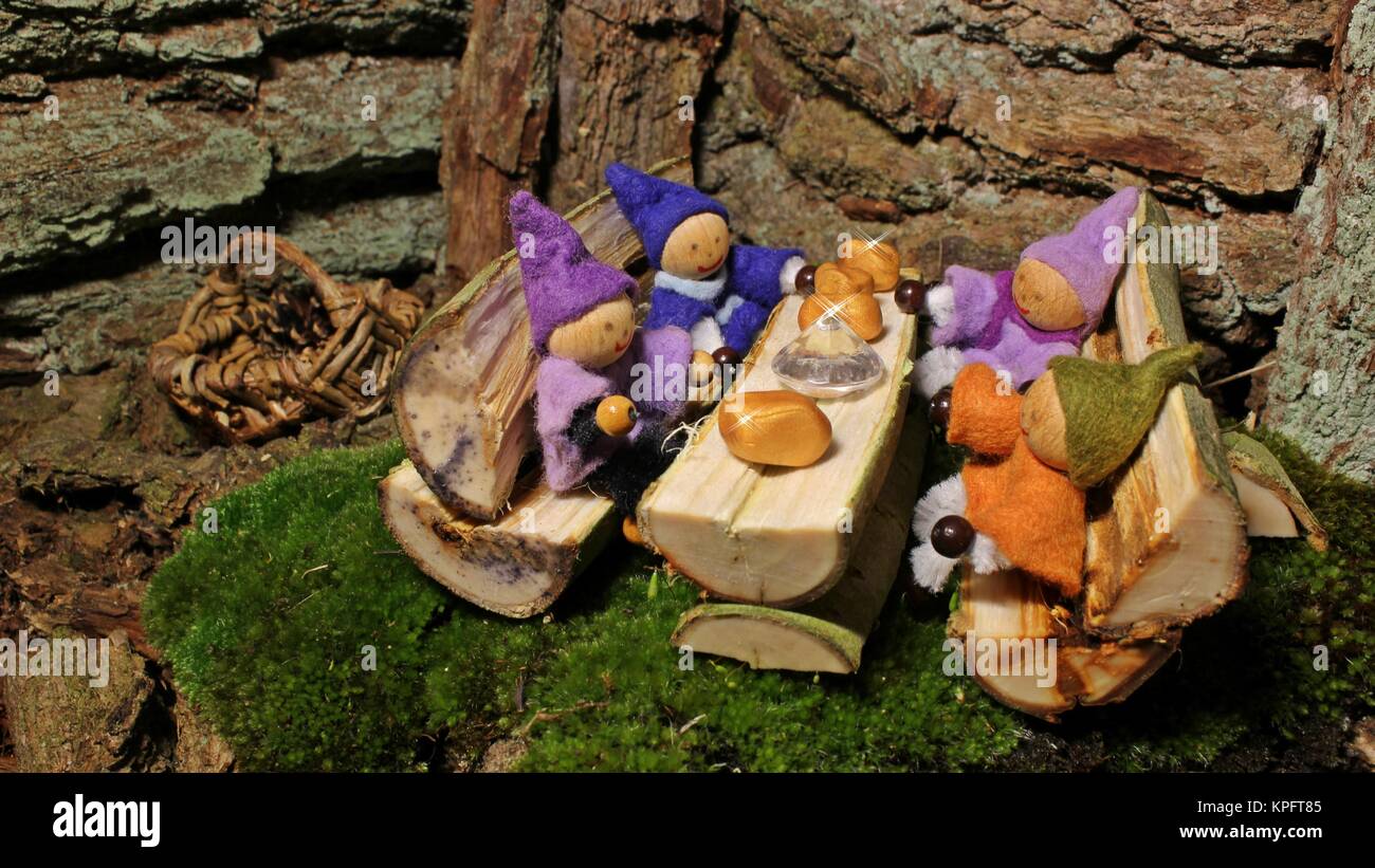 Four little gnomes with their treasure in the WichtelhÃ¶hle Stock Photo