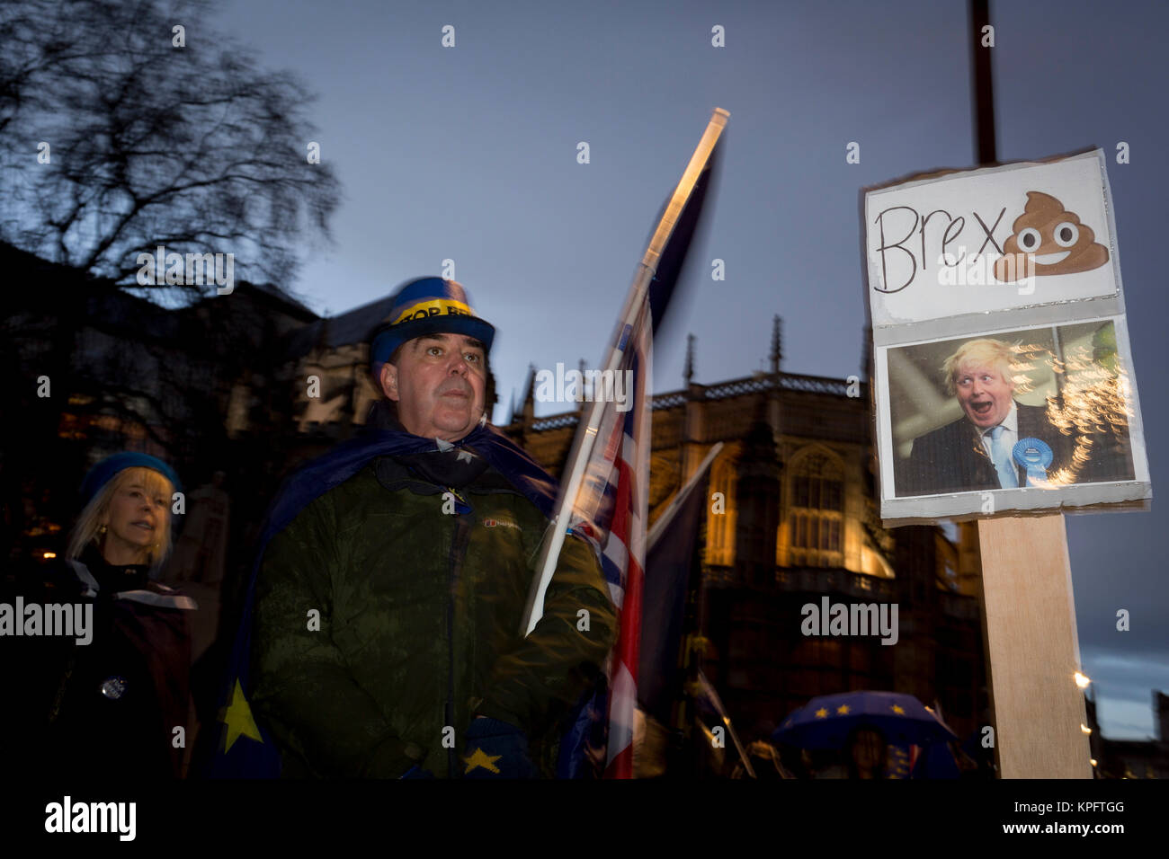 While MPs debate the Brexit Withdrawal Bill and ultimately vote in the House of Commons, Pro-EU Anti-Brexit protesters wave EU and Union Jack flags next to a parody of leading Brexiteer Boris Johnson outside Parliament, on 13th December 2017 in London, England. Stock Photo