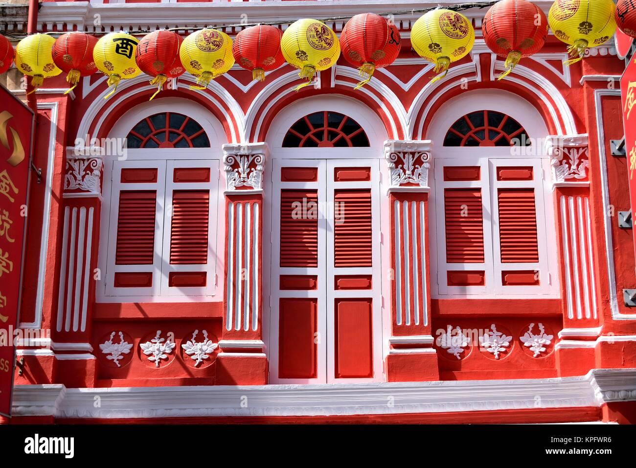 Chinese New Year lanterns strung across a traditional shop house in Chinatown, Singapore celebrating Chinese New Year. Stock Photo