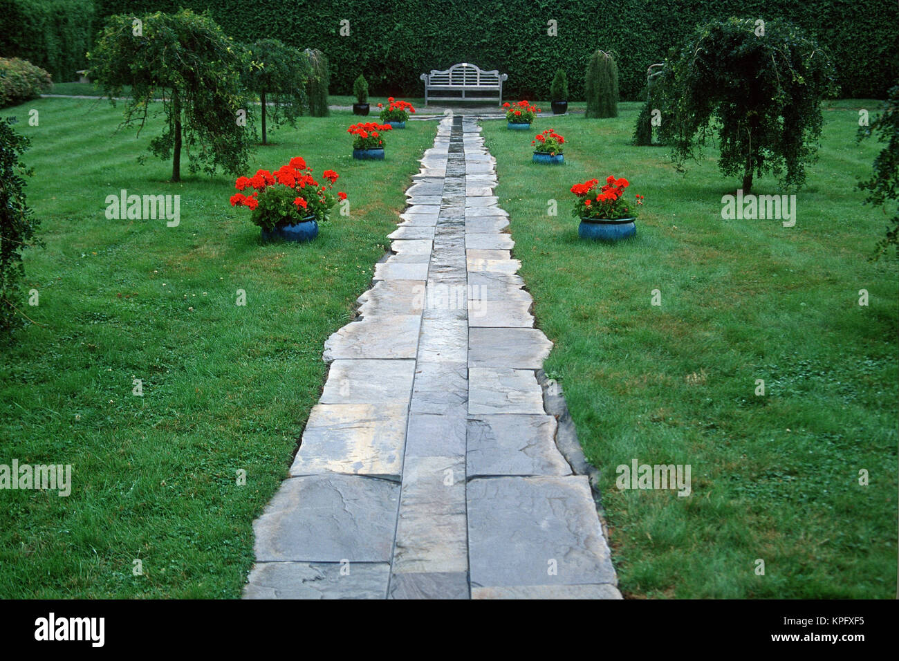 Canada, New Brunswick, St Andrews. Slate walkway leading towards a bench at KIngsbrae Garden Stock Photo