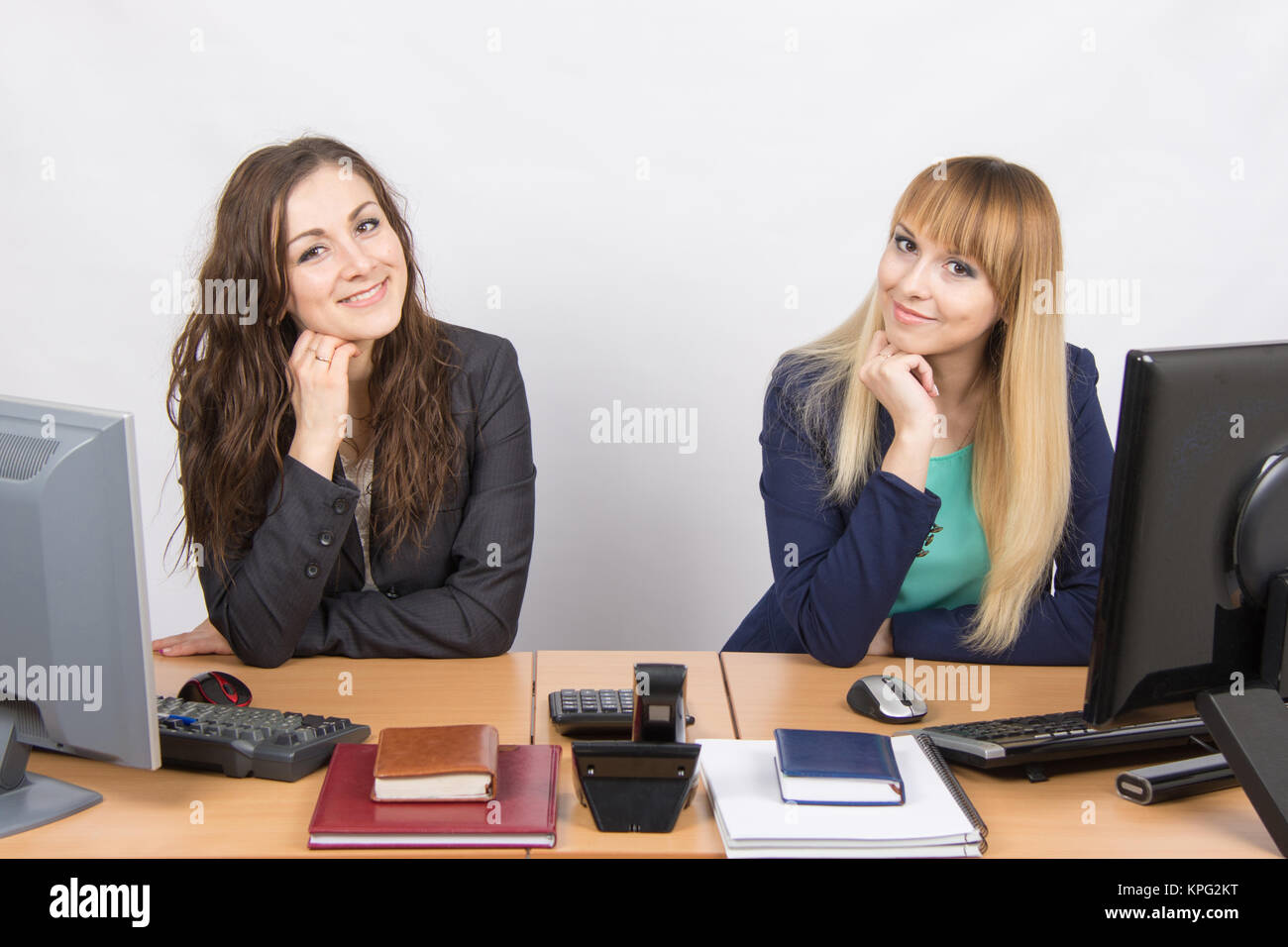 Two young girls newly recruited developing are in the workplace Stock Photo