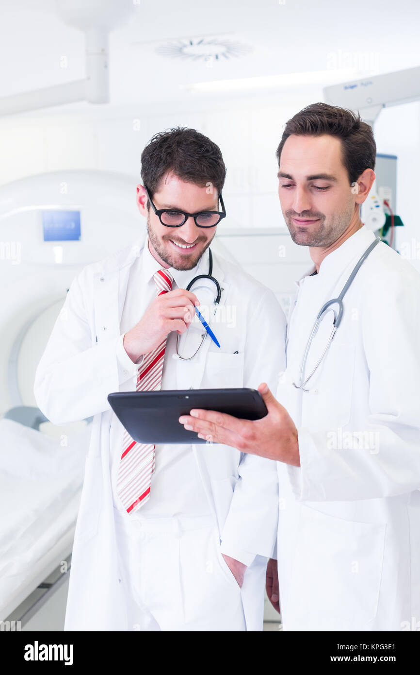 doctors discuss pictures of x-ray scan from tomograph Stock Photo