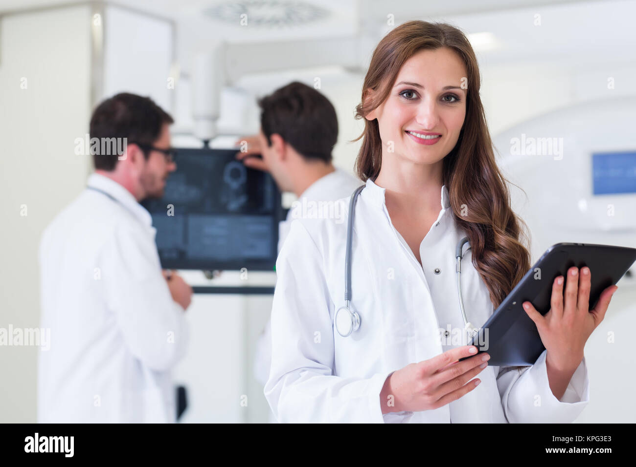 female doctor with colleagues in hospital at ct device Stock Photo