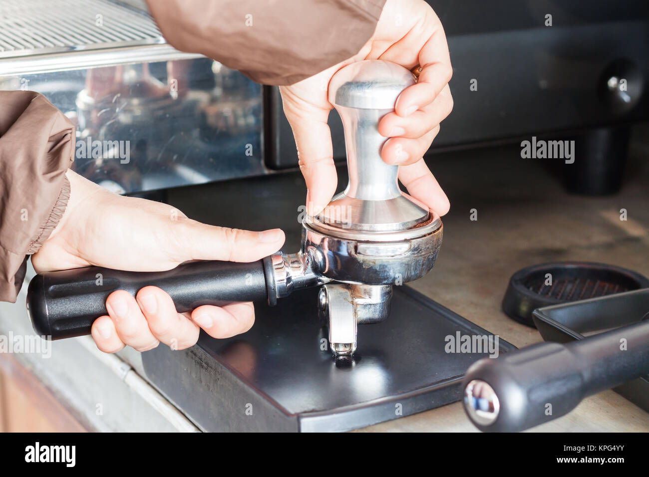 Barista with tamper for making espresso Stock Photo - Alamy