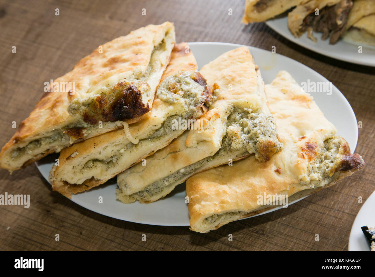 Traditional Georgian cheese and millet pie - khachapuri. The national cuisine of Georgia. Europe. Stock Photo