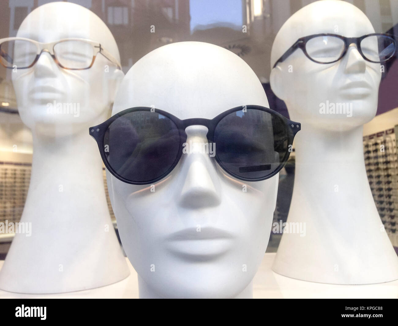 Three mannequin heads with glasses Stock Photo Alamy