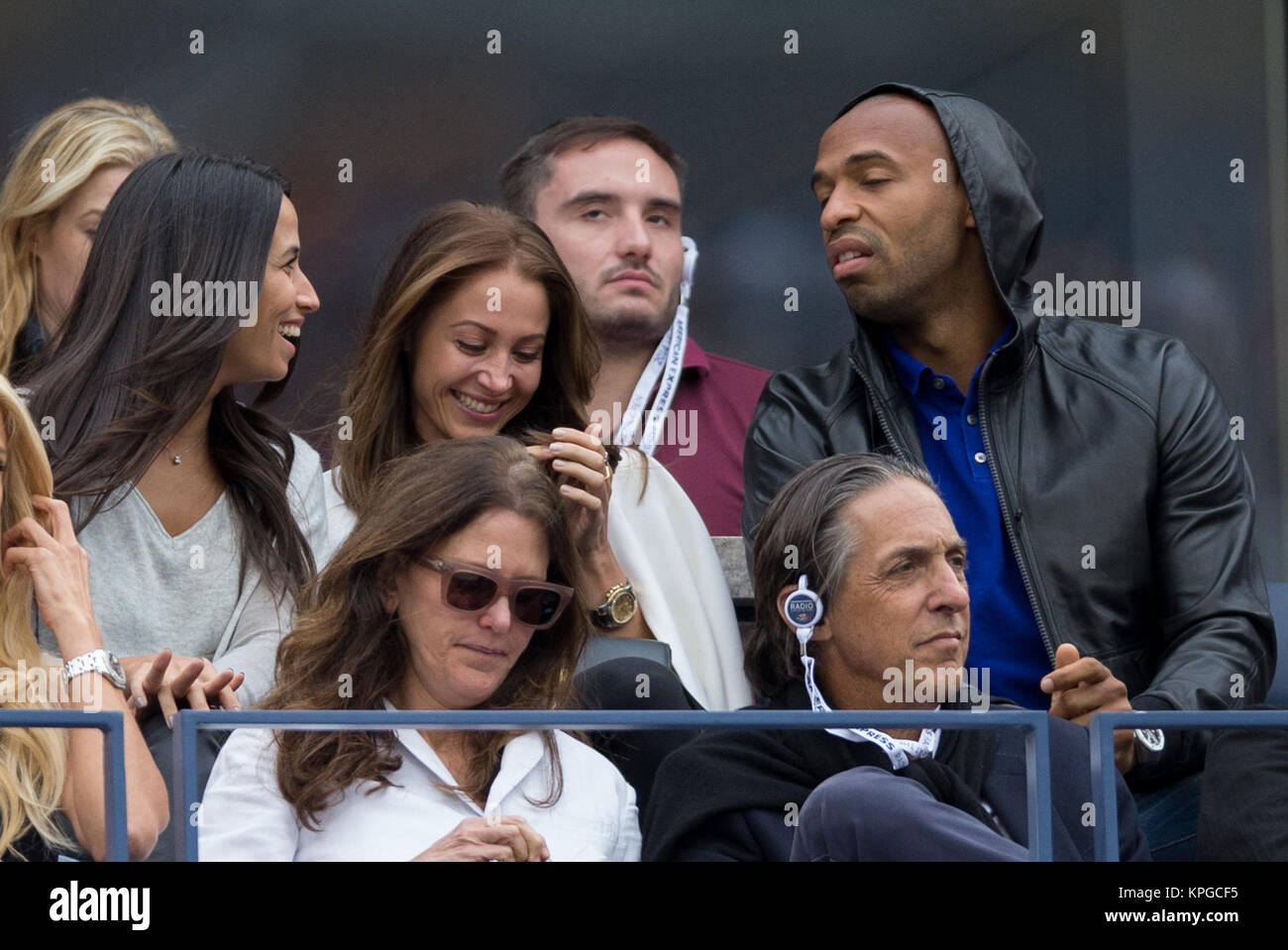 FLUSHING NY- SEPTEMBER 08: Axelle Francine, Andrea Rajacic, Thierry Henry, Vic, at the Mens Singles Finals Day fifteen of the 2014 US Open at the USTA Billie Jean King National Tennis Center on September 8, 2014 in the Flushing neighborhood of the Queens borough of New York City   People:  Axelle Francine, Andrea Rajacic, Thierry Henry, Vic Stock Photo