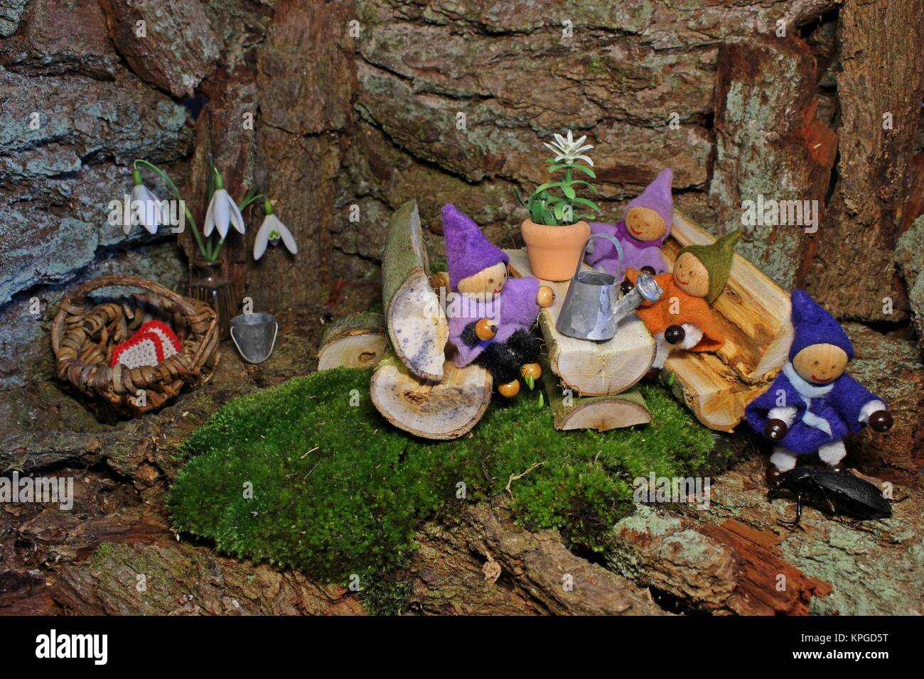 Four little gnomes in their wichtelhÃ¶hle with pet Stock Photo