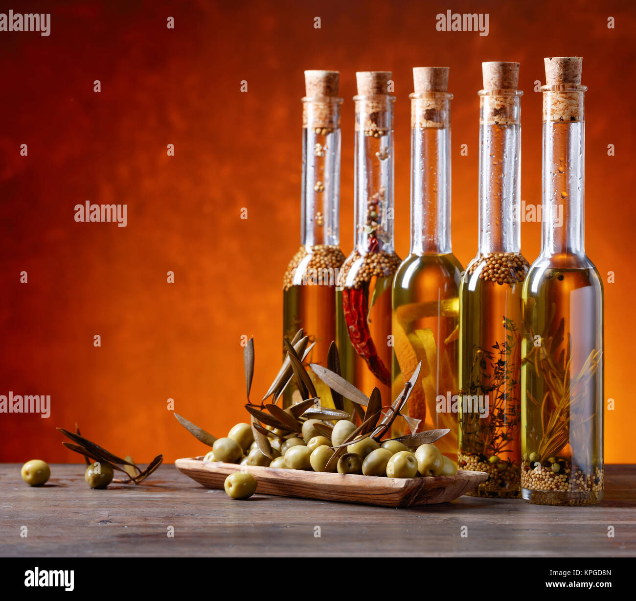 Green olives with leaves and bottles of olive oil Stock Photo - Alamy