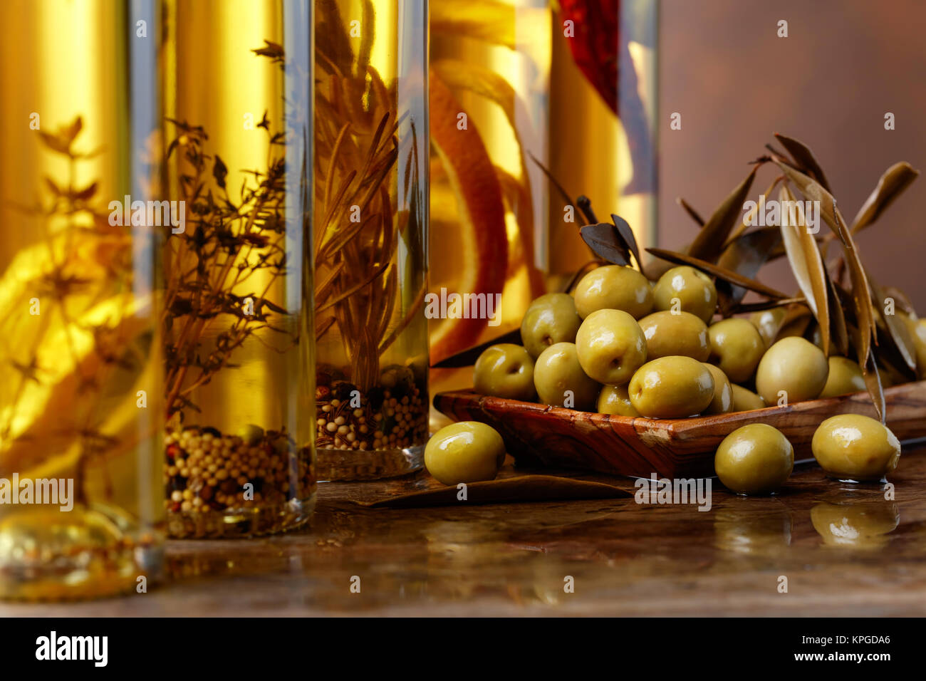 Green olives with leaves and bottles of olive oil Stock Photo - Alamy
