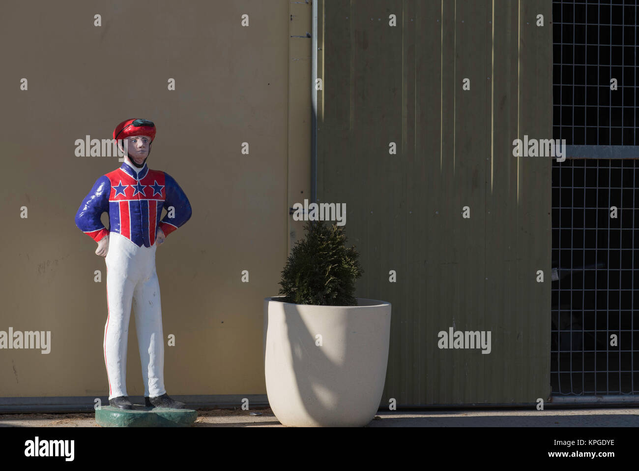 A model of a Trotting Racing Jockey stands outside a stable at the Bathurst Showground in Bathurst NSW, Australia Stock Photo