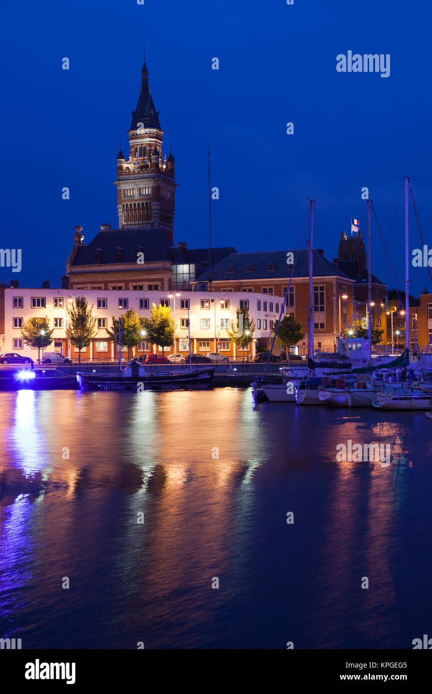 France, Nord, French Flanders, Dunkerque, Bassin du Commerce marina and town hall tower, dusk. Stock Photo
