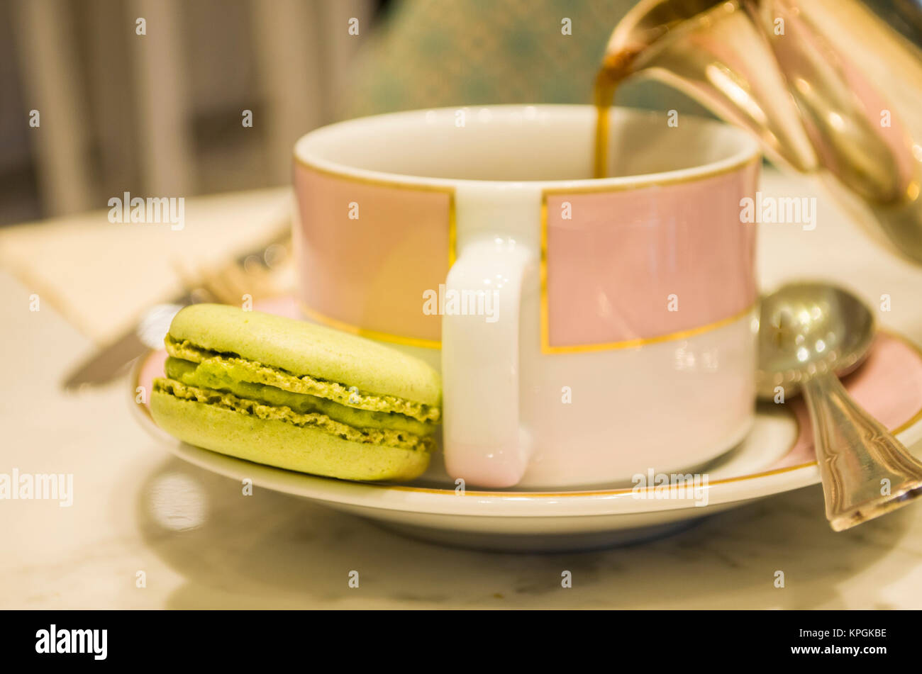 Morning Cup Of Coffee Cake Macaron And Flower On Light Background