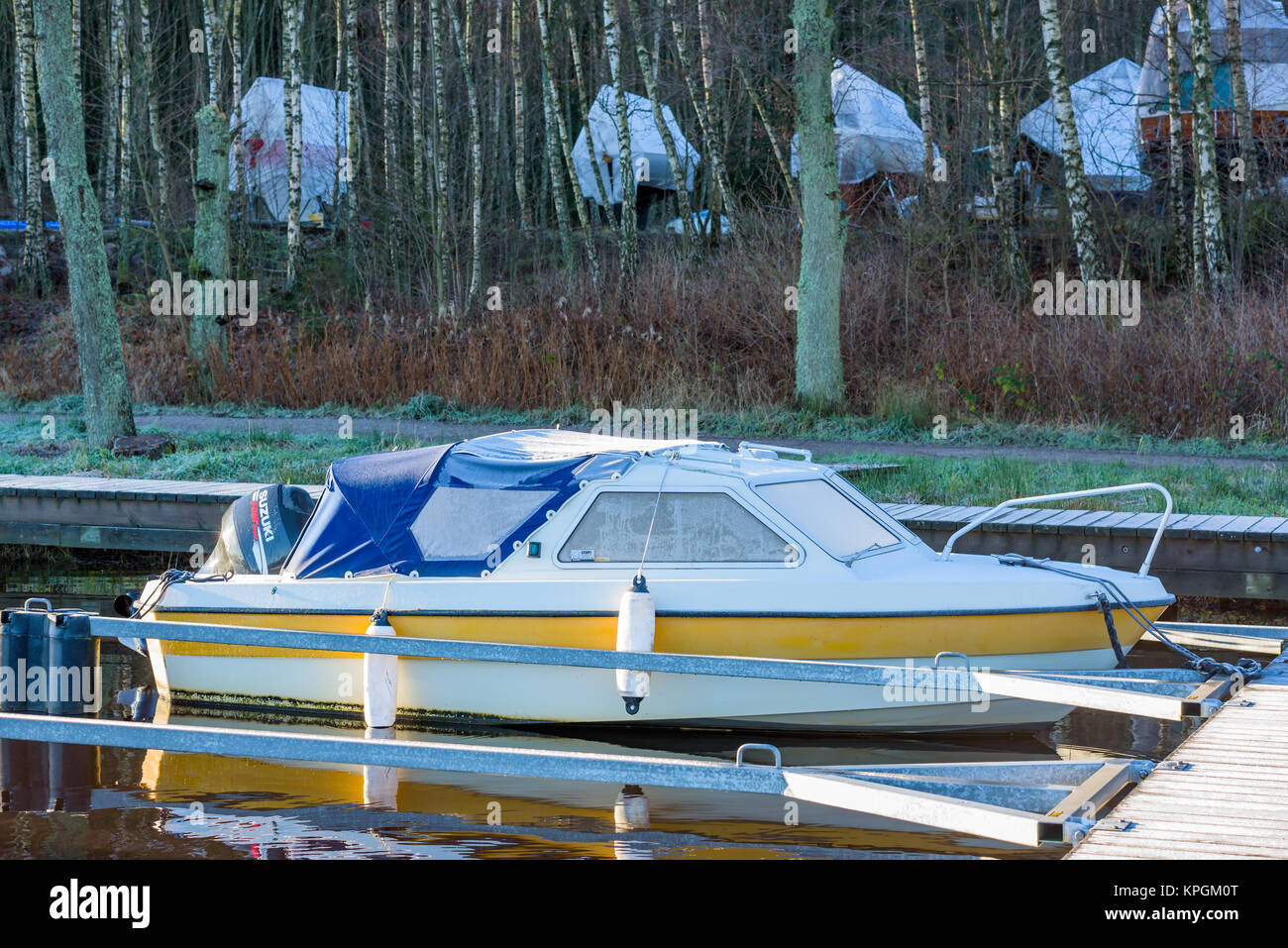 Nattraby, Sweden - November 13, 2017: Documentary of everyday life and environment. Motorboat in marina with frost on windows and tarp. Other boats in Stock Photo