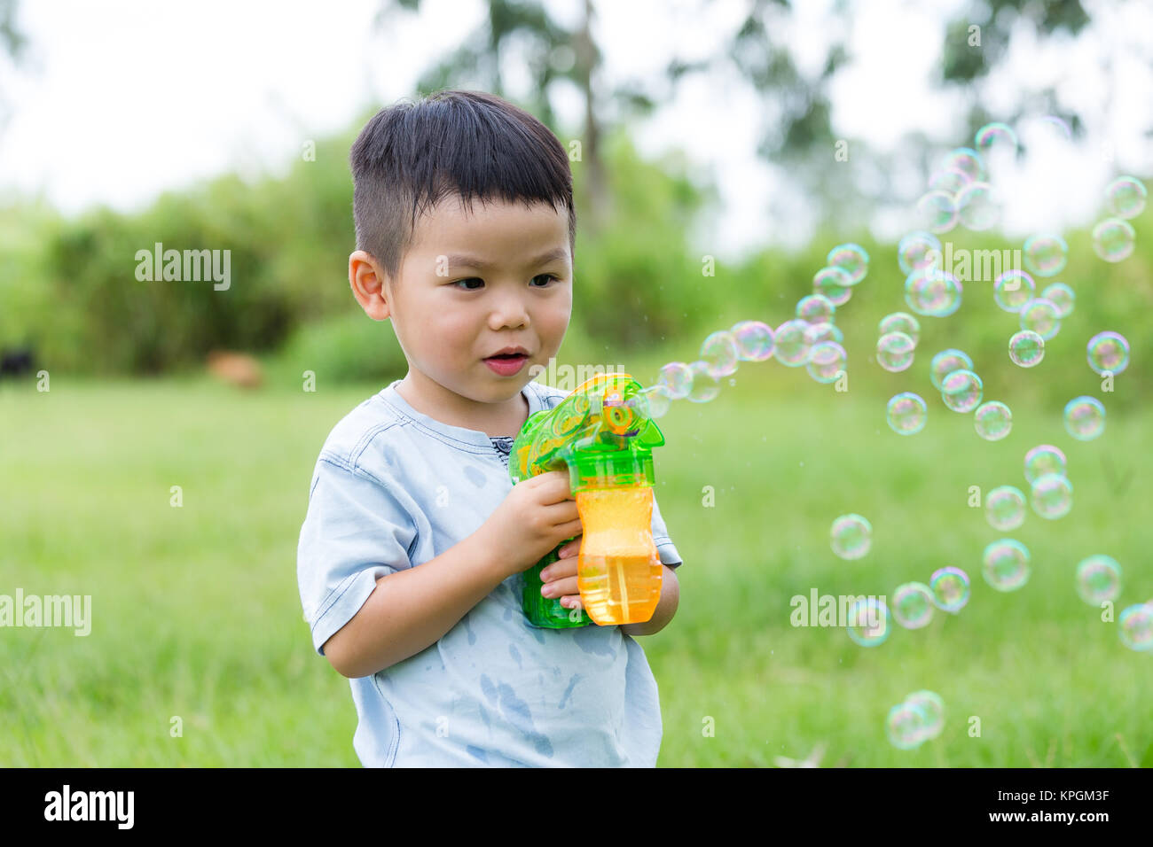 Asian boy play with bubble blower Stock Photo Alamy