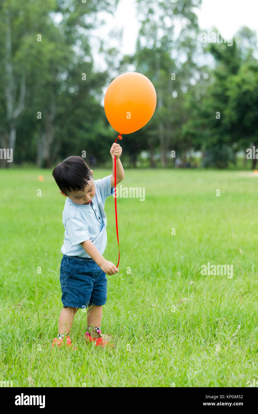 Asian little boy play balloon at outdoor Stock Photo