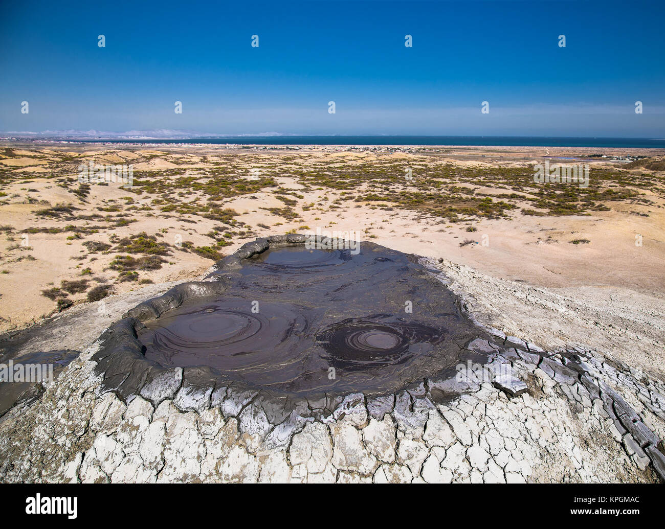 Top of mud crater volcano in Gobustan with eruption bubbling mud. Azerbaijan. Stock Photo