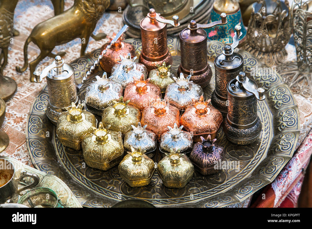 Old oriental antiques barass sugar bowl and caffee grinder on a tray at  street market in Baku city, Azerbeijan. Stock Photo