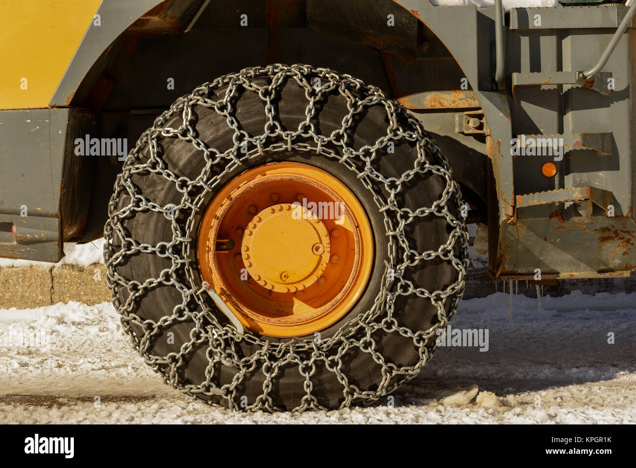Tractor tires with chains in the snow Stock Photo Alamy